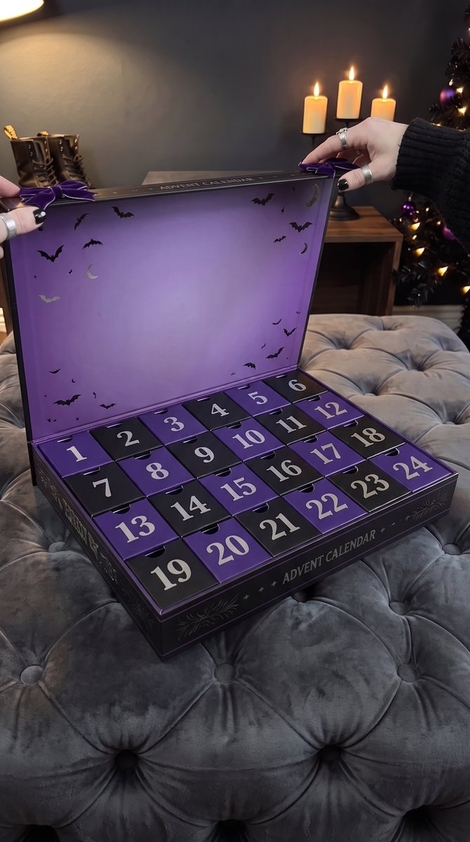 The calendar opened on a velvet ottoman, 24 black and violet doors, silver bats inside the lid