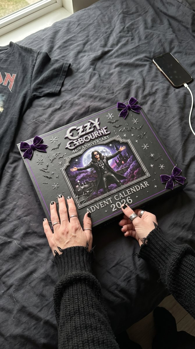 The closed calendar box held on a dark bed